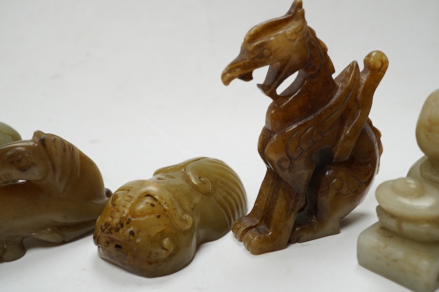 Four Chinese jade carvings, of a horse, cicada, a winged beast, a kneeling man, and a horned beast, longest 7cm. Condition - good